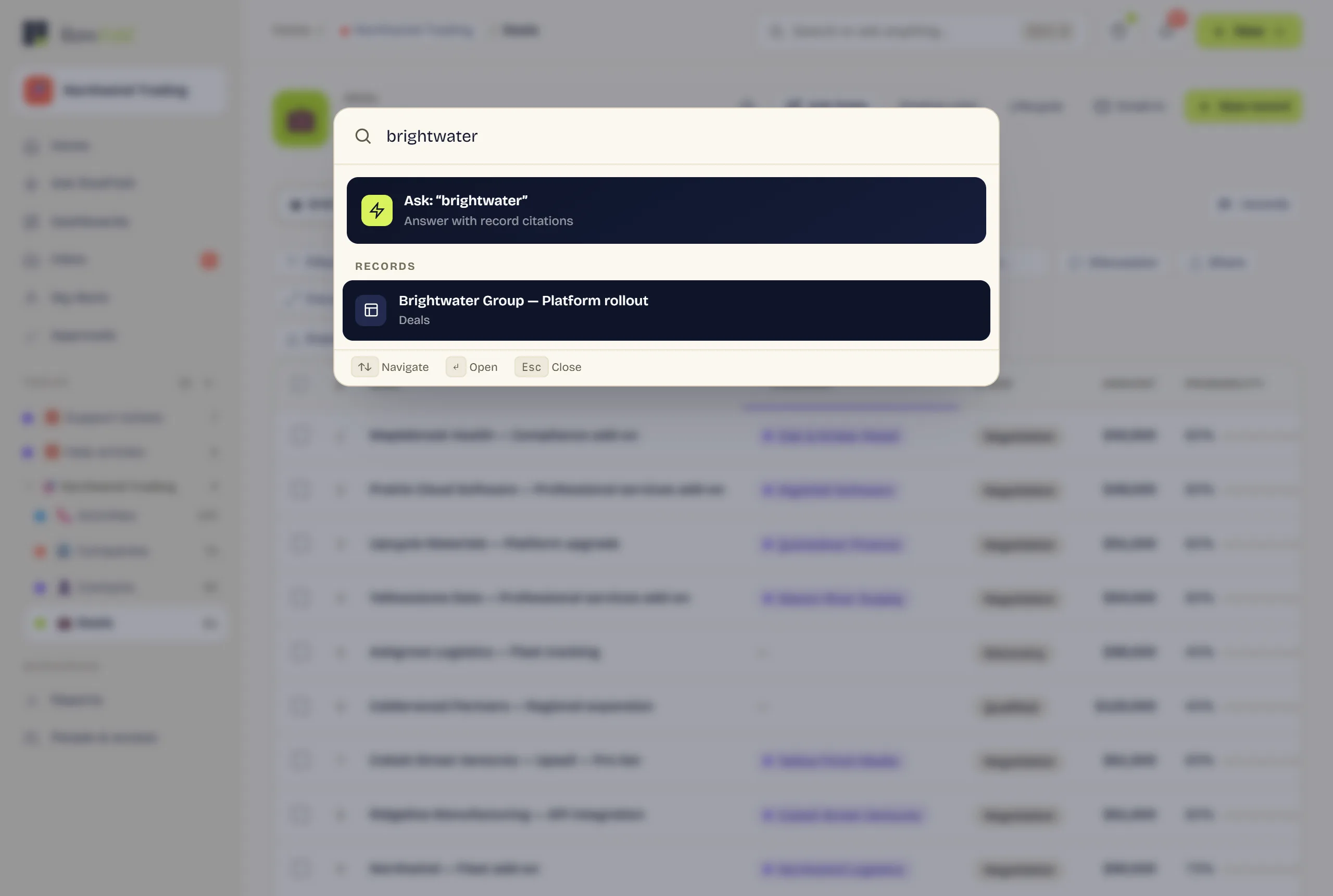 The command palette open over a dimmed grid, with “brightwater” typed in. It offers to ask RowFold that question and answer with record citations, and below, under a Records heading, the matching deal “Brightwater Group — Platform rollout”.